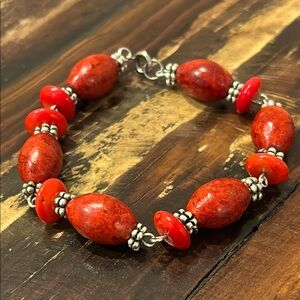 Red stone (?), silver (?) and bead (plastic) bracelet.